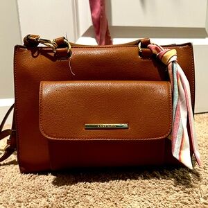 Spacious, brown purse with handles and long shoulder strap